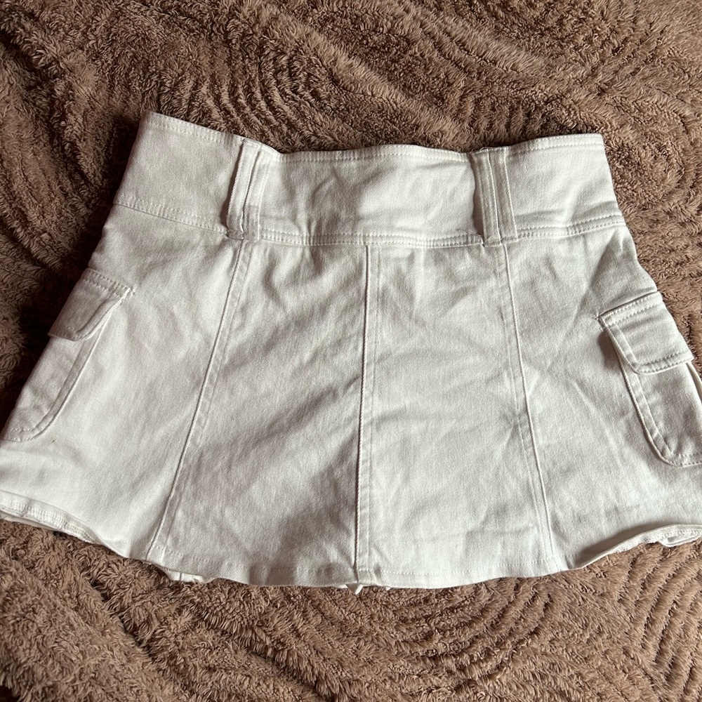 White Denim Mini Skirt with Utility Pockets and built in shorts. 100% Cotton.